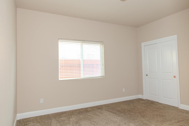 unfurnished bedroom featuring carpet flooring and baseboards