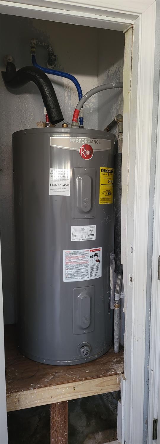 utility room with electric water heater