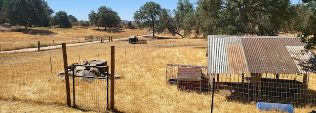 view of yard featuring a rural view and fence