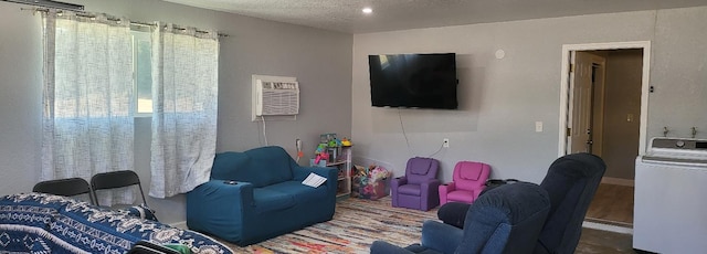 living area featuring washer / clothes dryer and a textured ceiling