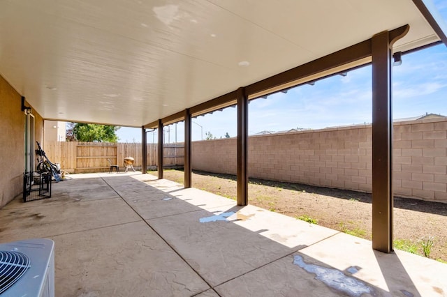view of patio / terrace with central air condition unit and a fenced backyard