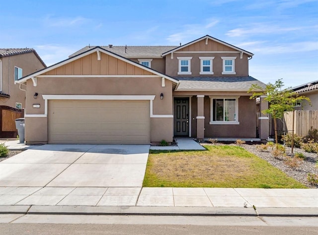 craftsman inspired home with board and batten siding, fence, an attached garage, stucco siding, and concrete driveway