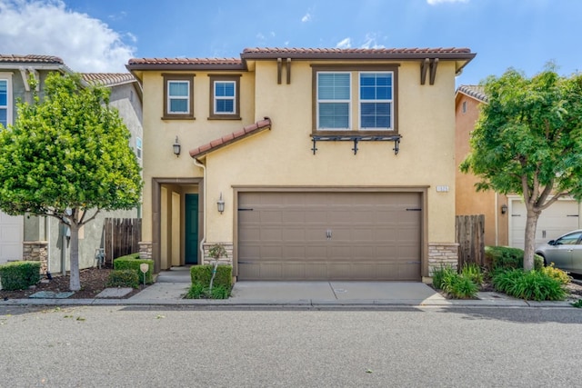1525 N Piccadilly Ln, Clovis, CA 93619 - mediterranean / spanish-style home with stone siding, a garage, a tiled roof, stucco siding, and driveway