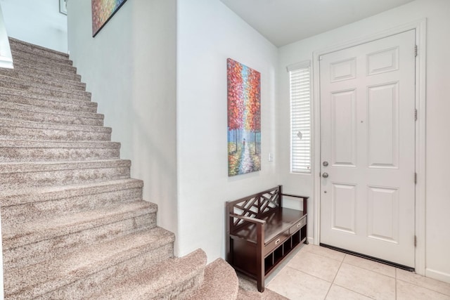 1525 N Piccadilly Ln, Clovis, CA 93619 - foyer entrance with light tile patterned floors, stairway, and baseboards