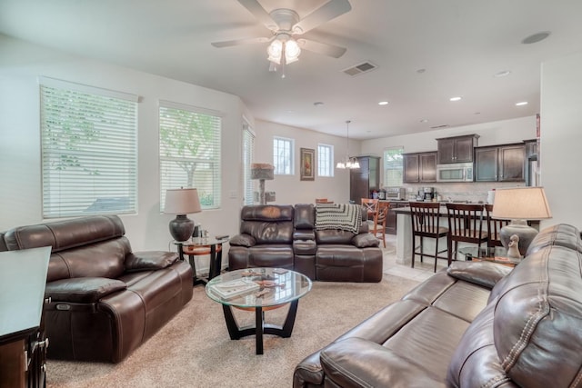 1525 N Piccadilly Ln, Clovis, CA 93619 - living room with light colored carpet, ceiling fan with notable chandelier, visible vents, and recessed lighting