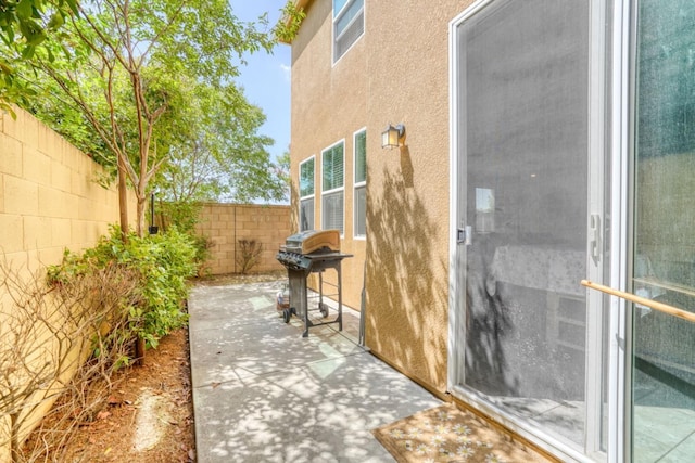 view of patio with a fenced backyard and grilling area