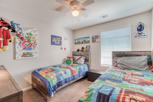 carpeted bedroom featuring baseboards, ceiling fan, and visible vents