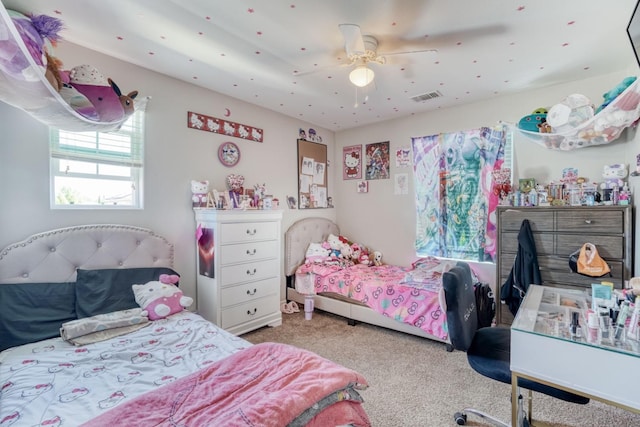 carpeted bedroom with visible vents and a ceiling fan