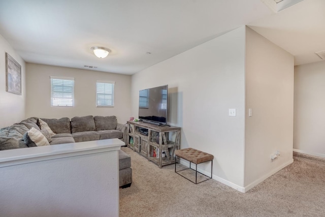 living room featuring baseboards, light carpet, and visible vents
