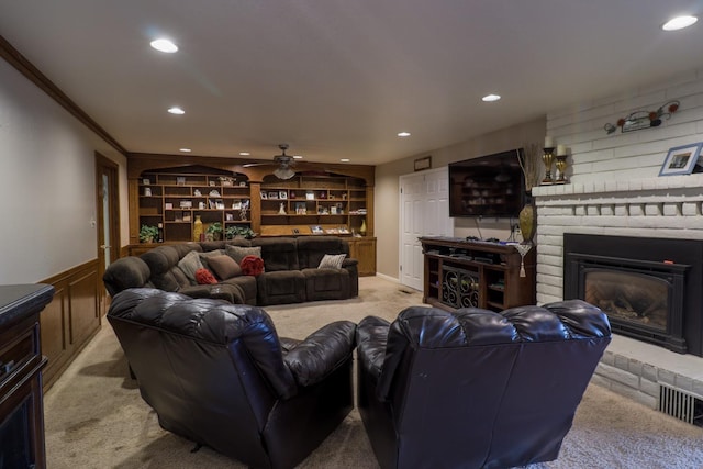 1233 Redwood Ln, Selma, CA 93662 - living room with light carpet, recessed lighting, a brick fireplace, ceiling fan, and crown molding