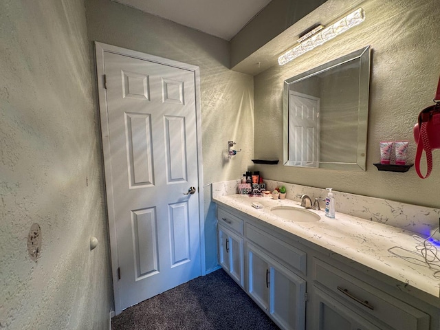 1233 Redwood Ln, Selma, CA 93662 - bathroom featuring vanity and a textured wall