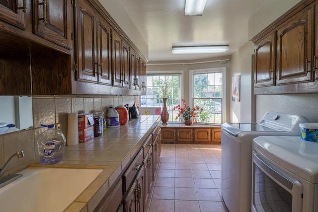 1233 Redwood Ln, Selma, CA 93662 - laundry room with separate washer and dryer, cabinet space, and light tile patterned floors