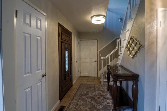 1233 Redwood Ln, Selma, CA 93662 - tiled entrance foyer featuring stairs and a textured wall