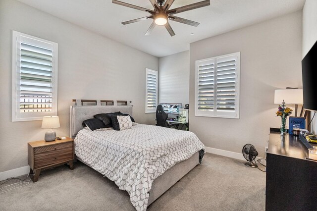 bedroom with carpet, baseboards, multiple windows, and ceiling fan