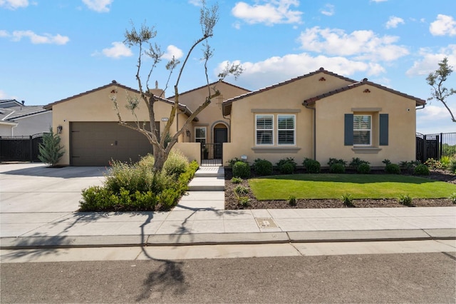 view of front of home featuring stucco siding, concrete driveway, an attached garage, a gate, and a tiled roof