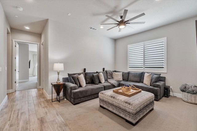 living room with a ceiling fan, recessed lighting, baseboards, and light wood finished floors