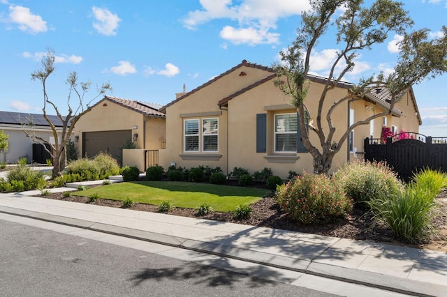 view of front of house with stucco siding, a garage, and a tile roof