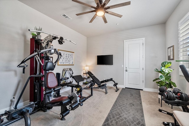workout area featuring ceiling fan, carpet, and baseboards