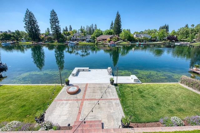 dock area with a yard and a water view