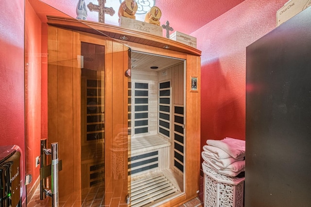 view of sauna / steam room with a textured wall