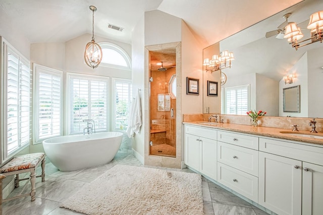 bathroom featuring a sink, an inviting chandelier, lofted ceiling, and visible vents