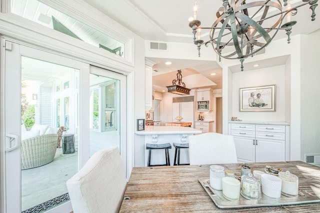 dining space featuring recessed lighting, an inviting chandelier, and visible vents