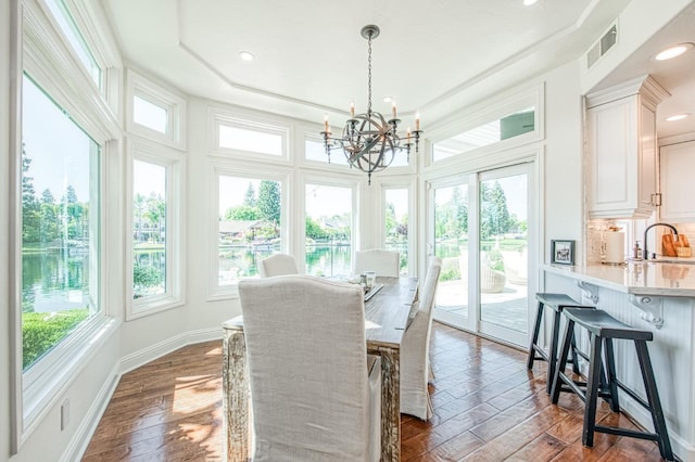 sunroom / solarium featuring recessed lighting, a healthy amount of sunlight, a chandelier, and visible vents