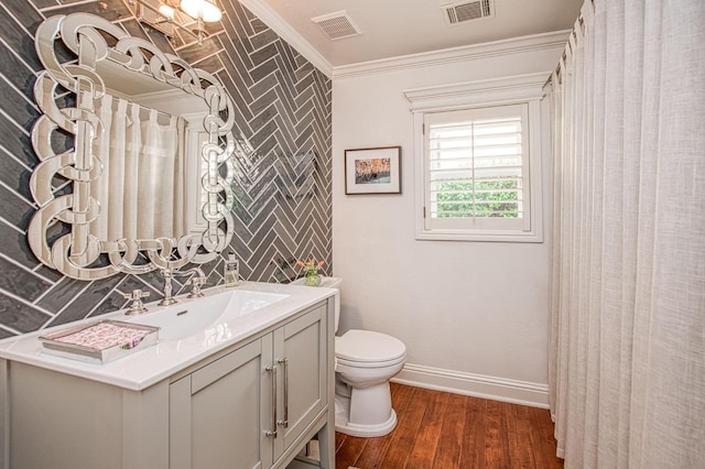 full bath with crown molding, toilet, visible vents, and wood finished floors