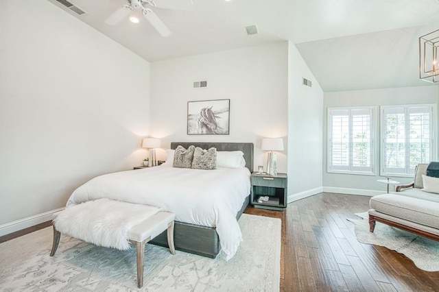 bedroom featuring vaulted ceiling, baseboards, visible vents, and hardwood / wood-style floors