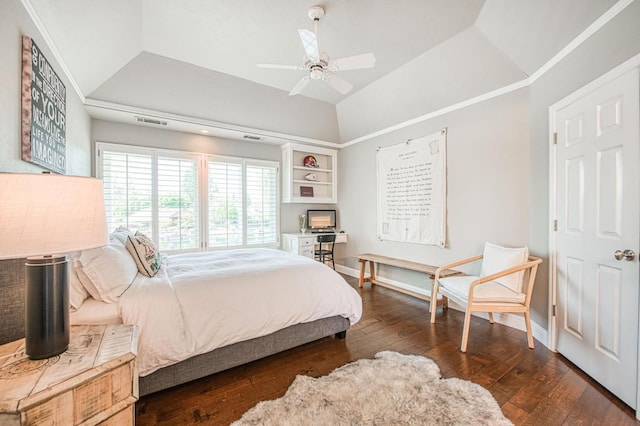 bedroom featuring lofted ceiling, a ceiling fan, a tray ceiling, baseboards, and wood-type flooring