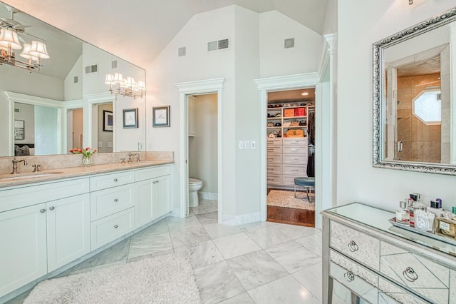full bath with a sink, a notable chandelier, and visible vents