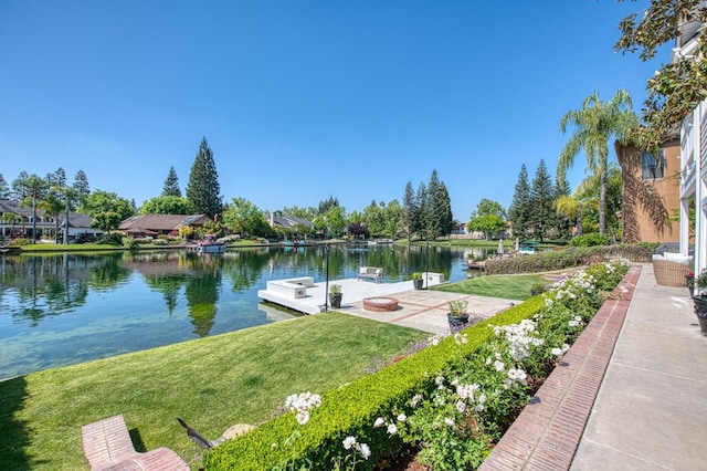 dock area featuring a yard and a water view