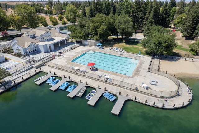 bird's eye view of a pool area and a nearby body of water