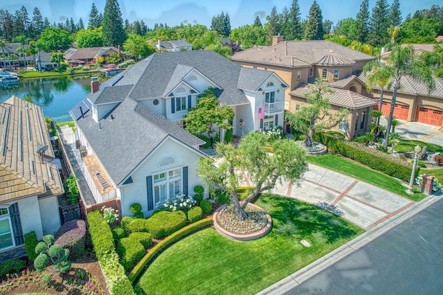 drone / aerial view with a water view and a residential view