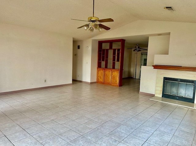 725 18th, Delano, CA 93212 - unfurnished living room featuring a ceiling fan, light tile patterned floors, a glass covered fireplace, visible vents, and vaulted ceiling