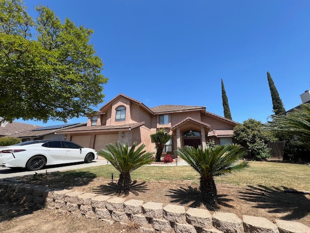 view of front of property with fence, a tile roof, a garage, stucco siding, and a front lawn