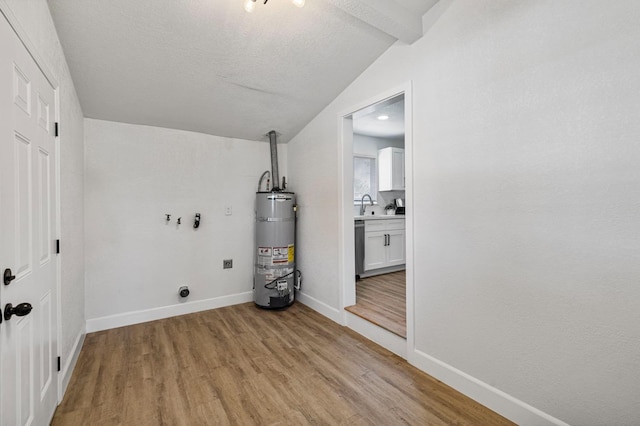 washroom with light wood-style flooring, baseboards, secured water heater, laundry area, and electric dryer hookup