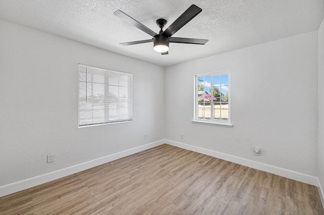 unfurnished room with baseboards, a textured ceiling, a ceiling fan, and wood finished floors
