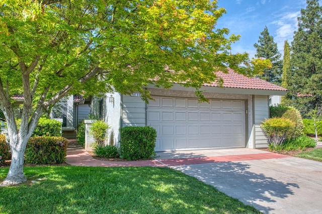 garage featuring concrete driveway