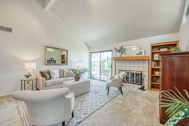 carpeted living room featuring a fireplace, high vaulted ceiling, and visible vents
