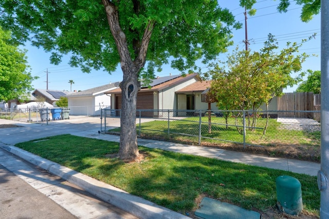 single story home featuring driveway, solar panels, a garage, and a gate