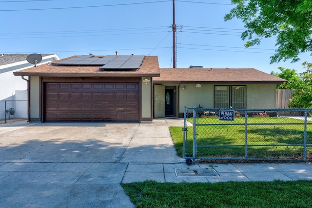 single story home with stucco siding, solar panels, a gate, and an attached garage