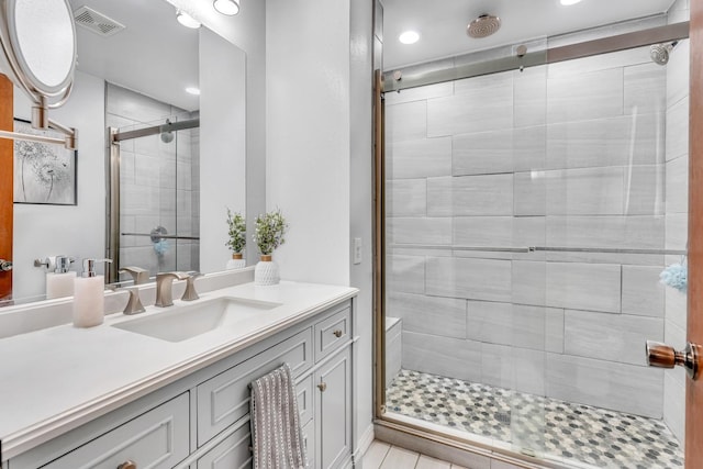 full bath featuring a stall shower, vanity, and recessed lighting