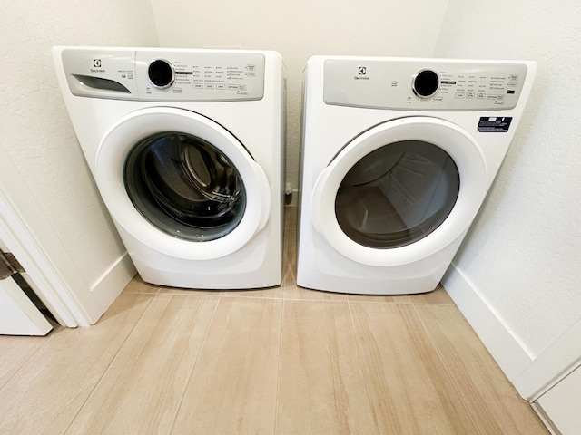 laundry room with washing machine and clothes dryer