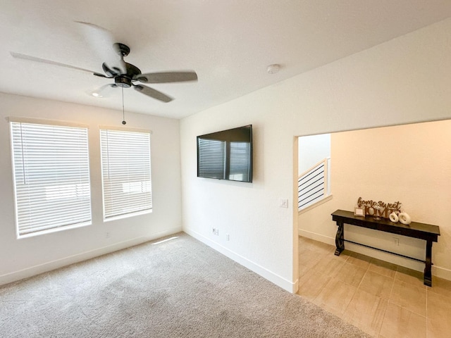 unfurnished room with ceiling fan, baseboards, and carpet floors