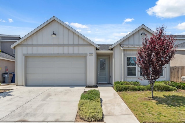 5091 N San Clemente Ave, Fresno, CA 93723 - view of front facade with board and batten siding, driveway, an attached garage, and roof with shingles