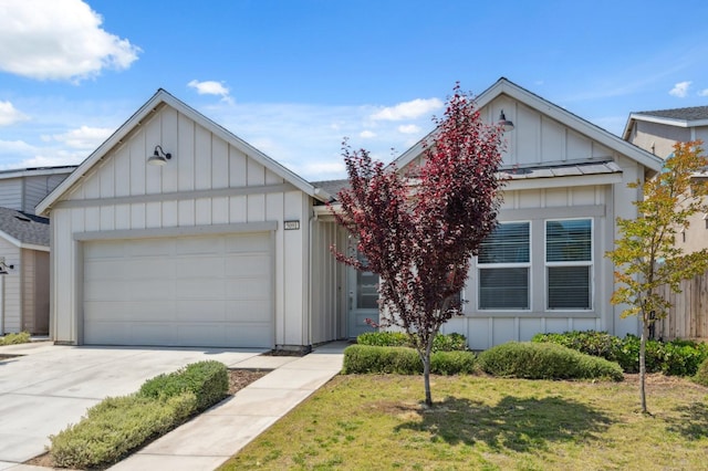 5091 N San Clemente Ave, Fresno, CA 93723 - view of front of property with board and batten siding, an attached garage, concrete driveway, and a front lawn
