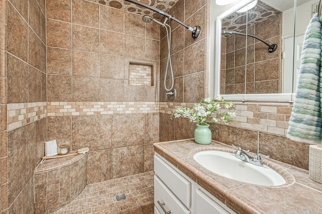 4693 E Church Ave, Fresno, CA 93725 - bathroom featuring tiled shower, vanity, and tile walls