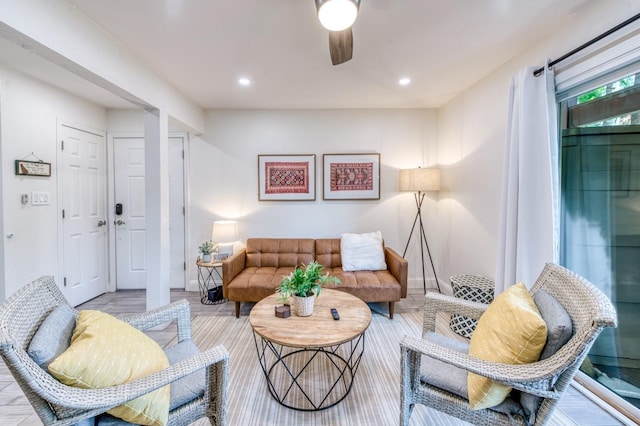 living area with a ceiling fan, recessed lighting, baseboards, and wood finished floors