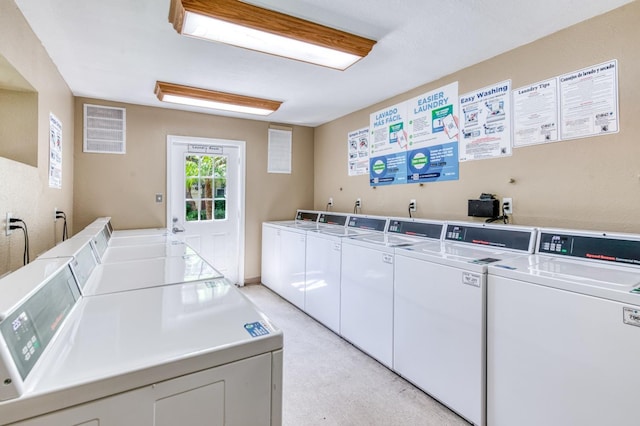 communal laundry room featuring washer and clothes dryer